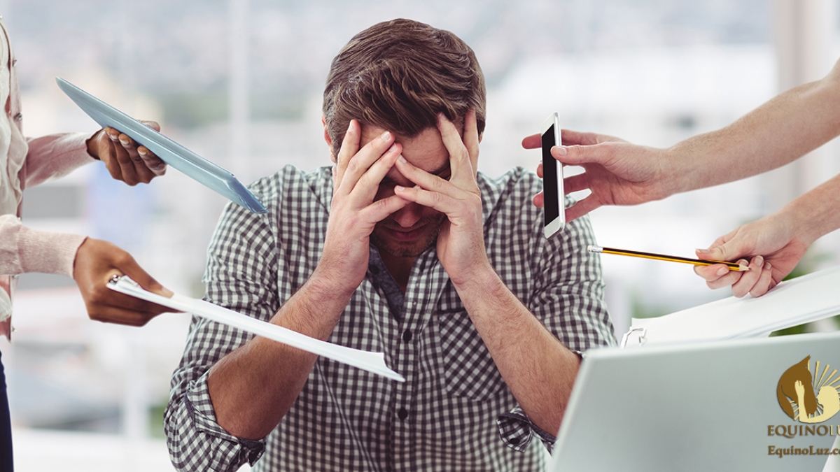Stressed man frustrated with electronic devices in office