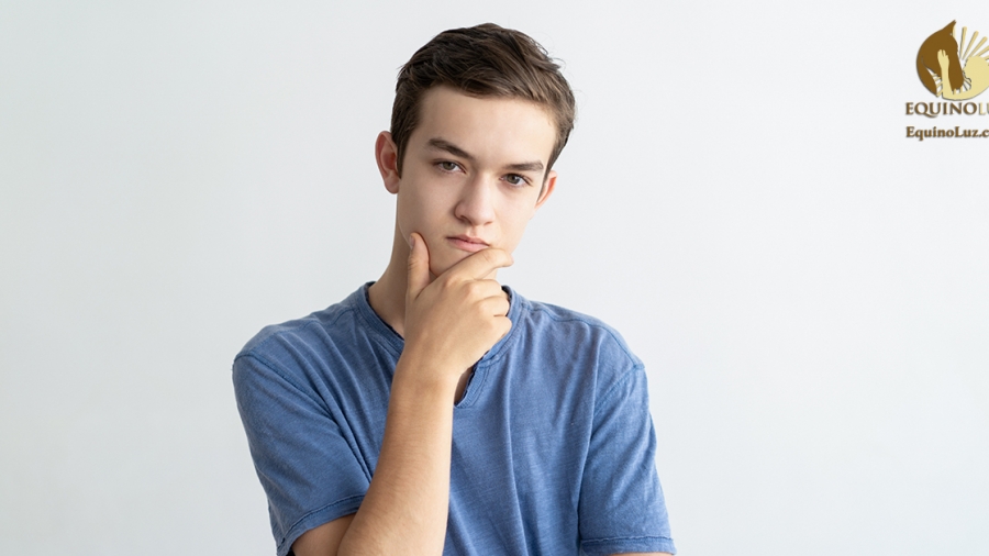 Thoughtful teenage guy thinking over problem solving. Pensive serious young man in casual touching chin and looking at camera. Finding solution concept